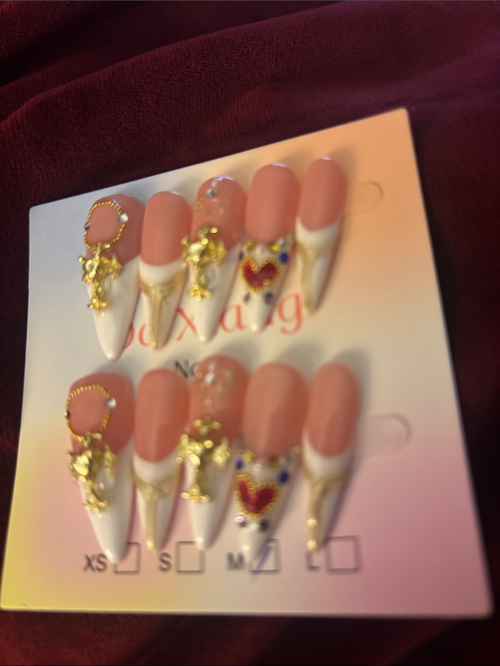 Short Stiletto Press-On Nails in Nude Pink and White with Gold Accents